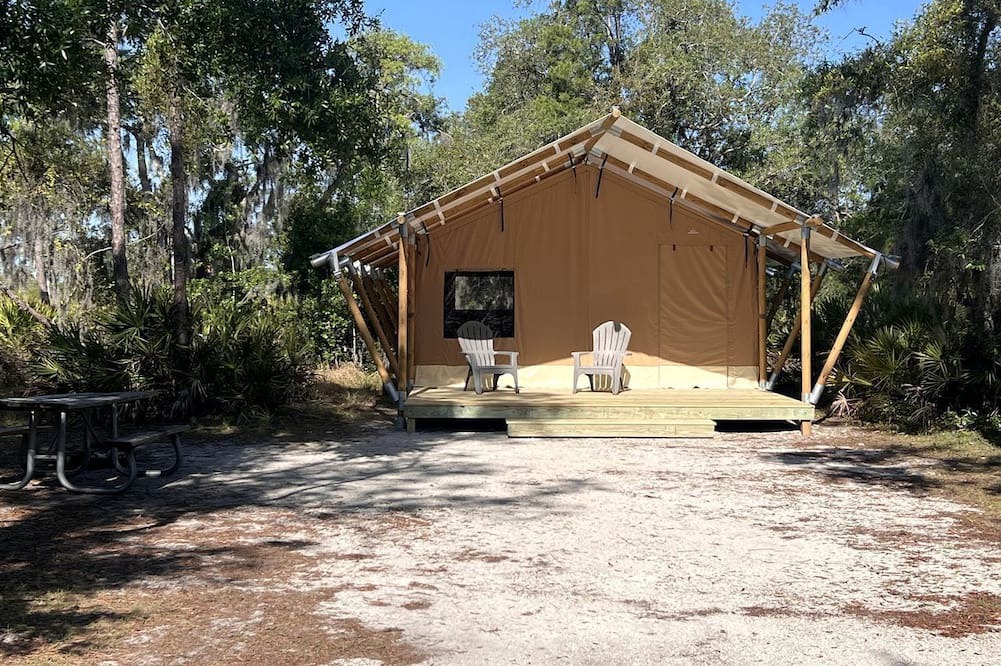 Braden River RV Rental | Luxurious Deluxe Safari Tent with King Bed and Outdoor Fire Pit in Bradenton, Florida