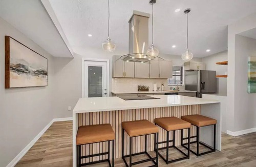 Bayshore Gardens House | Bayshore Gardens remodel with hot tub + fire pit + walk to park.