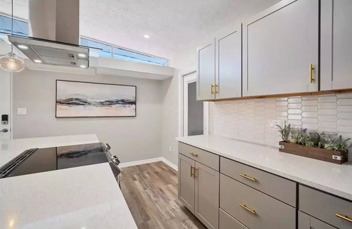 Bayshore Gardens House | Bayshore Gardens remodel with hot tub + fire pit + walk to park.
