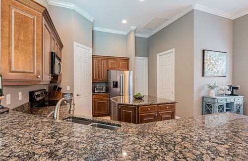 Central Naples House | Briarwood Upscale home with two primary suite-heated pool & spa- entertaining area w/TV