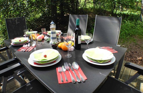 Gohren House | Child-friendly vacation home Hagebutte 263 in Baabe. Awarded the FeWoAirClean seal. Wellness indulgence with a sauna and hot tub. Wooden deck with patio furniture surrounded by nature