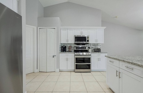 Trafalgar Villa | Hot Tub & Private Pool · Screened Lanai · Game Room · BBQ · Canal View