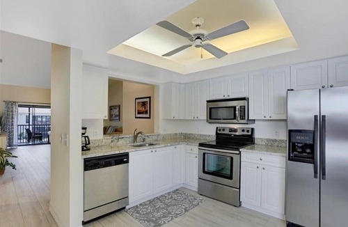 Pelican Bay Condo | Pelican Bay Condo overlooking pool and gardens, with private beach access.