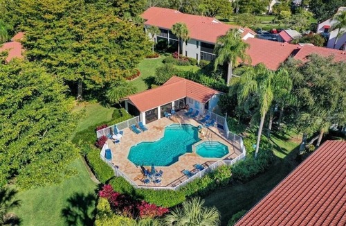 Pelican Bay Condo | Pelican Bay Condo overlooking pool and gardens, with private beach access.