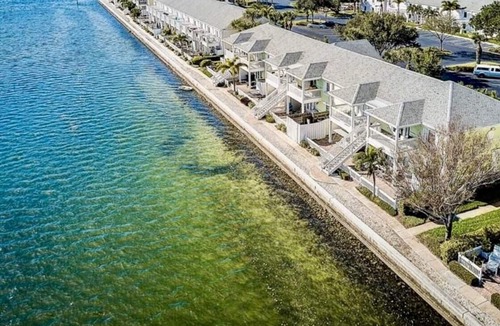 Coquina Key Condo | Resort style Luxury condo on the waterfront with private patio overlooking bay.
