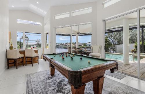 Pelican House | Riverfront Luxury with Heated Pool, Spa & Private Dock - Sunny Shores Escape