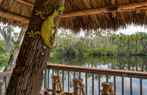 Braden River Apartment | Riverside Breeze Tropical Retreat w Tiki Hut&BBQ
