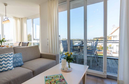 Grossenbrode Apartment | Vacation apartment Strandperle 9 in Großenbrode. Wonderful balcony to relax on. Exclusive wellness oasis with sauna & corner bathtub. Seasonal beach chair included. Practical washing machine available