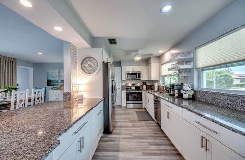 Caloosahatchee Villa | Villa Tropical Vibes - Charming 3 BR waterfront Villa with heated pool, bicycles, fishing poles - walking distance to bars and restaurants