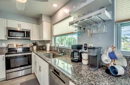 Caloosahatchee Villa | Villa Tropical Vibes - Charming 3 BR waterfront Villa with heated pool, bicycles, fishing poles - walking distance to bars and restaurants