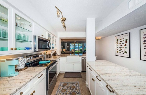 Isla del Sol Condo | Waterfront 2BR condo with pool, hot tub, balcony, and water views.