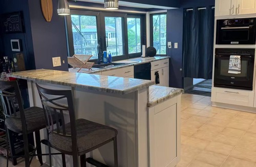 Palm Harbor House | Waterfront Lake Tarpon Home with heated salt water pool, fitness room, WiFi