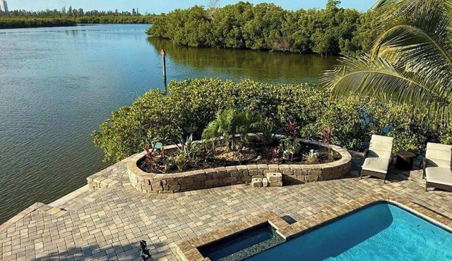 Immaculate bay front home w/in ground pool, spa, paver patio & porch