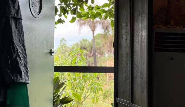 Luxury off-grid passionfruit covered shipping container immersed in nature.