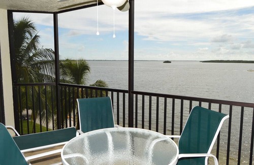 Punta Rassa Condo | Sanibel Harbour Resort Harbour Tower 315: Relaxing while watching for dolphins in the water below.